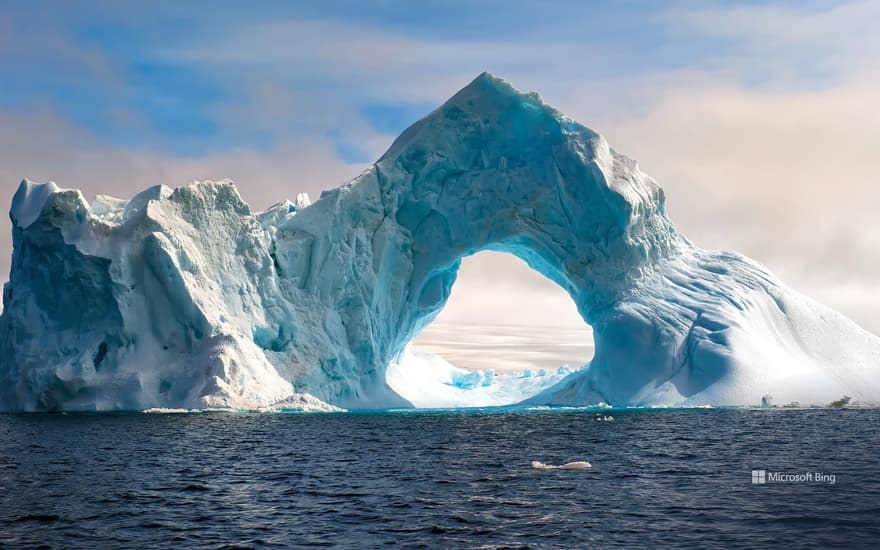 Natural arch carved in an iceberg, Antarctica