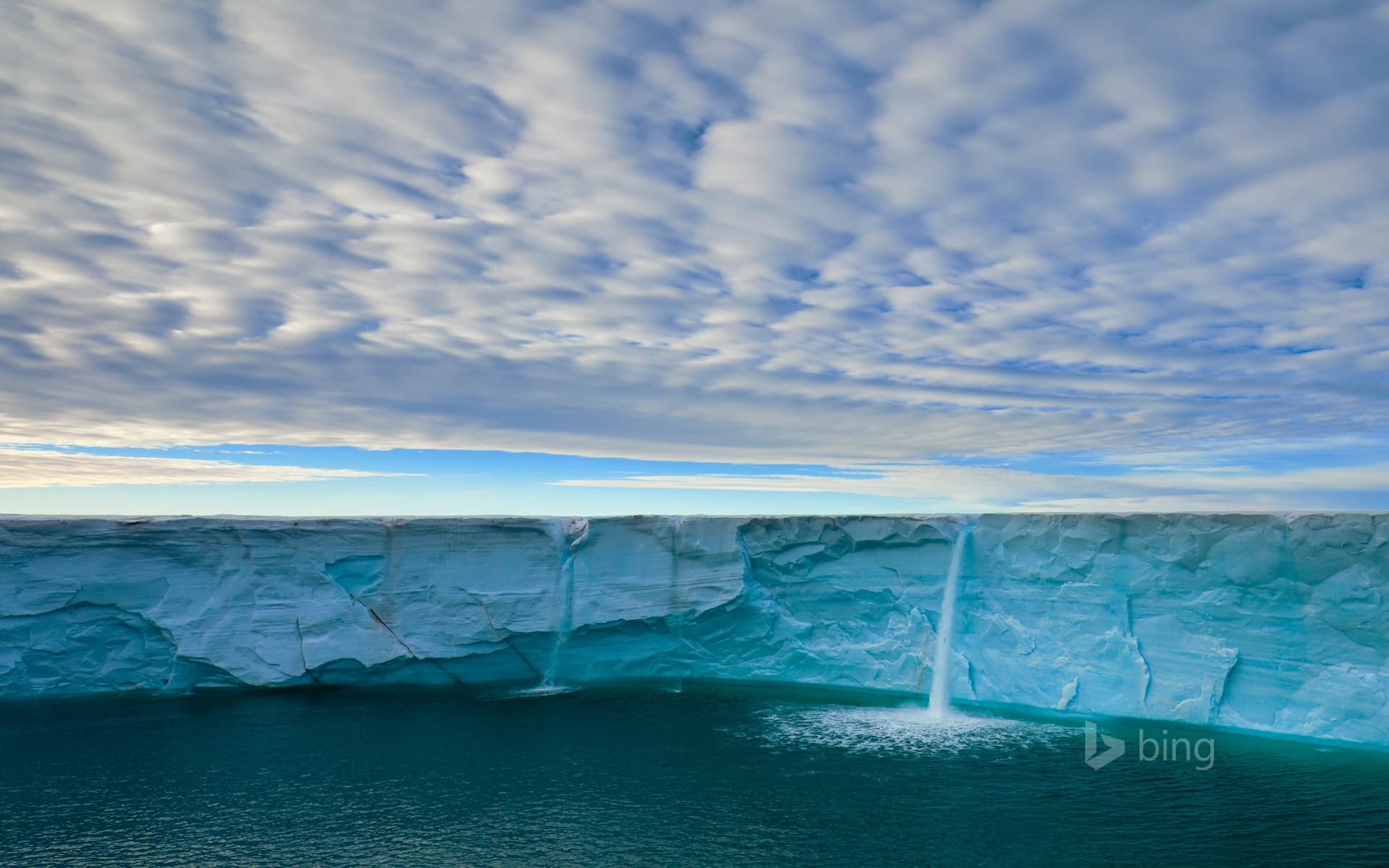 Bing Wallpaper: Meltwater creates waterfalls on an ice cap, Svalbard Archipelago, Norway