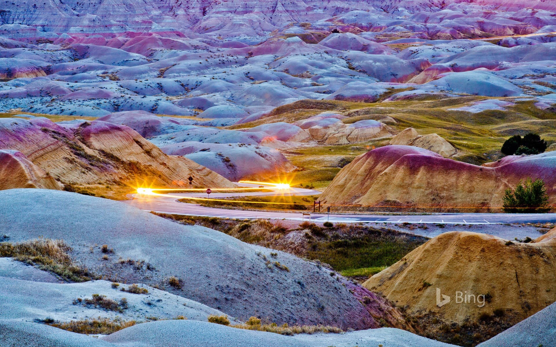 Bing Wallpaper: Headlights streaking through Badlands National Park, South Dakota