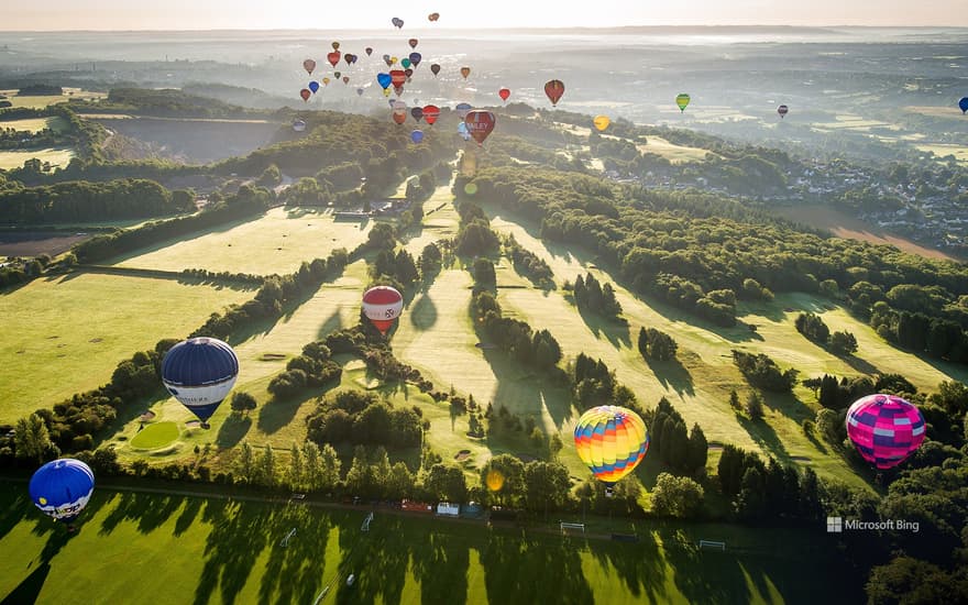 Hot air balloons over a golf course during the Bristol International Balloon Fiesta
