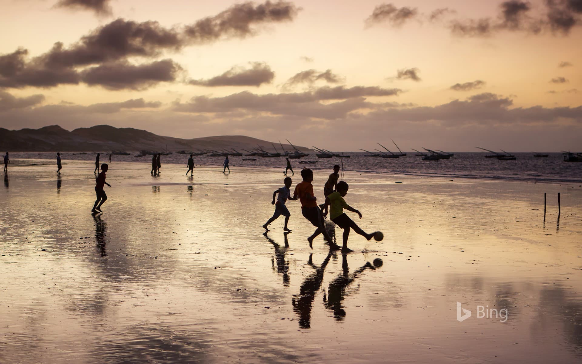 Bing Wallpaper: Young boys playing soccer on a beach in Ceará state, Brazil