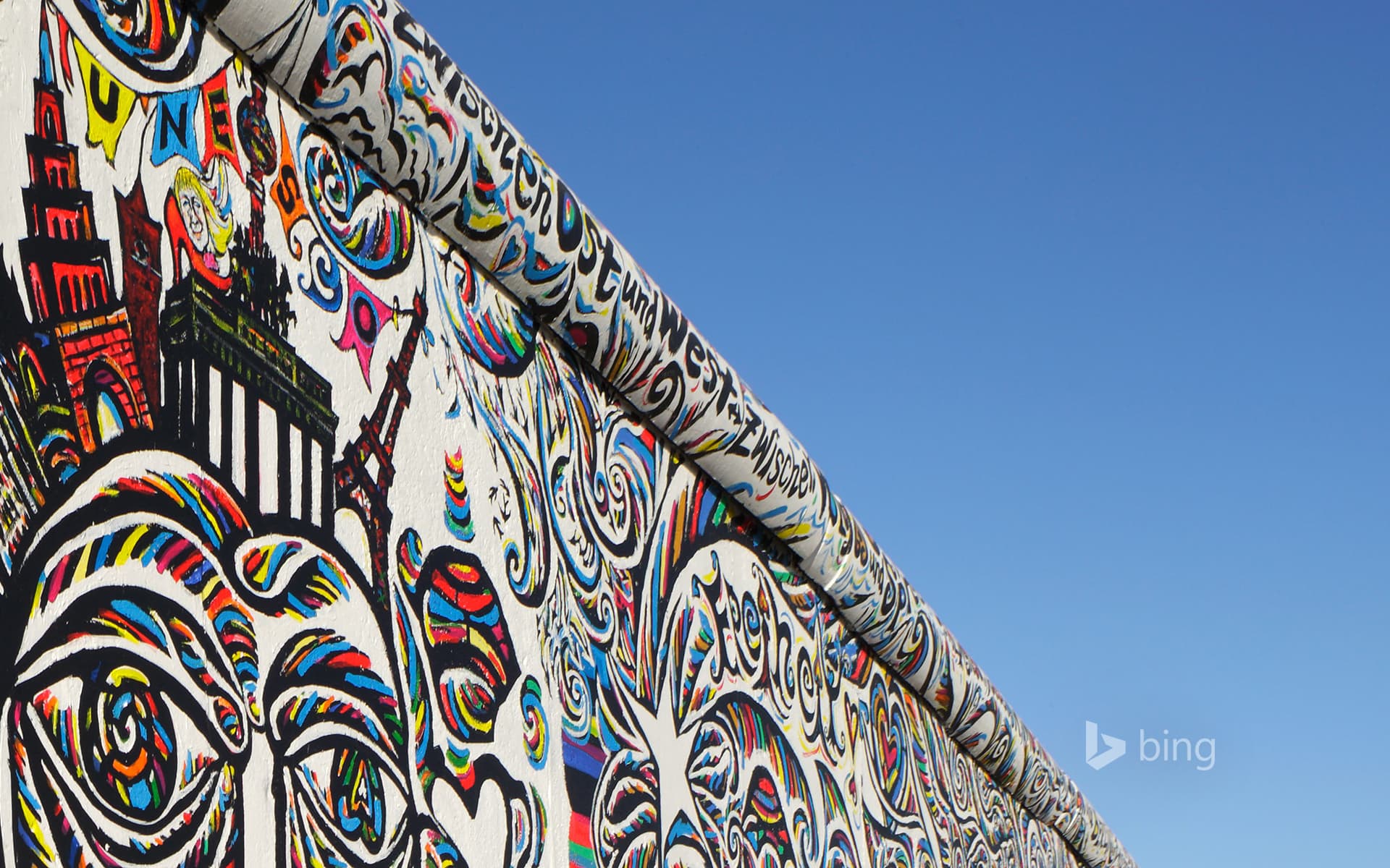 Bing Wallpaper: Shamil Gimajew’s ‘We Are A People’ on the renovated East Side Gallery of the Berlin Wall, Berlin, Germany