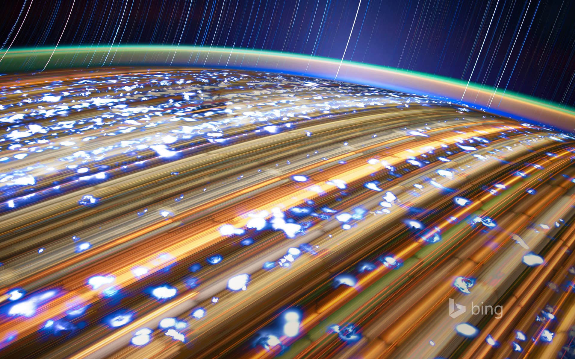 Bing Wallpaper: Stacked, long exposures of Earth taken from the International Space Station