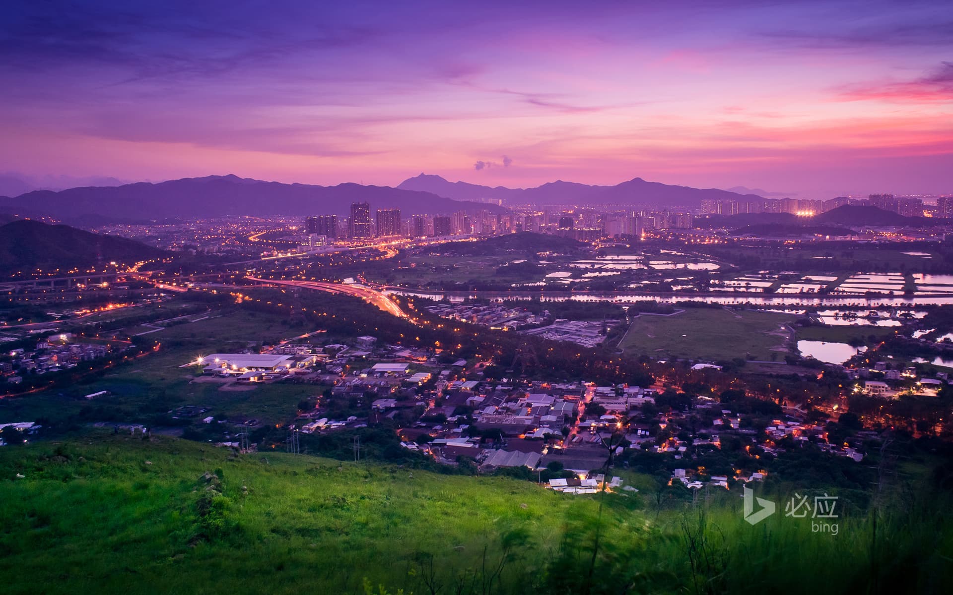 Bing Wallpaper: Enjoy the scenery of Yuen Long from a hill in Hong Kong at sunset