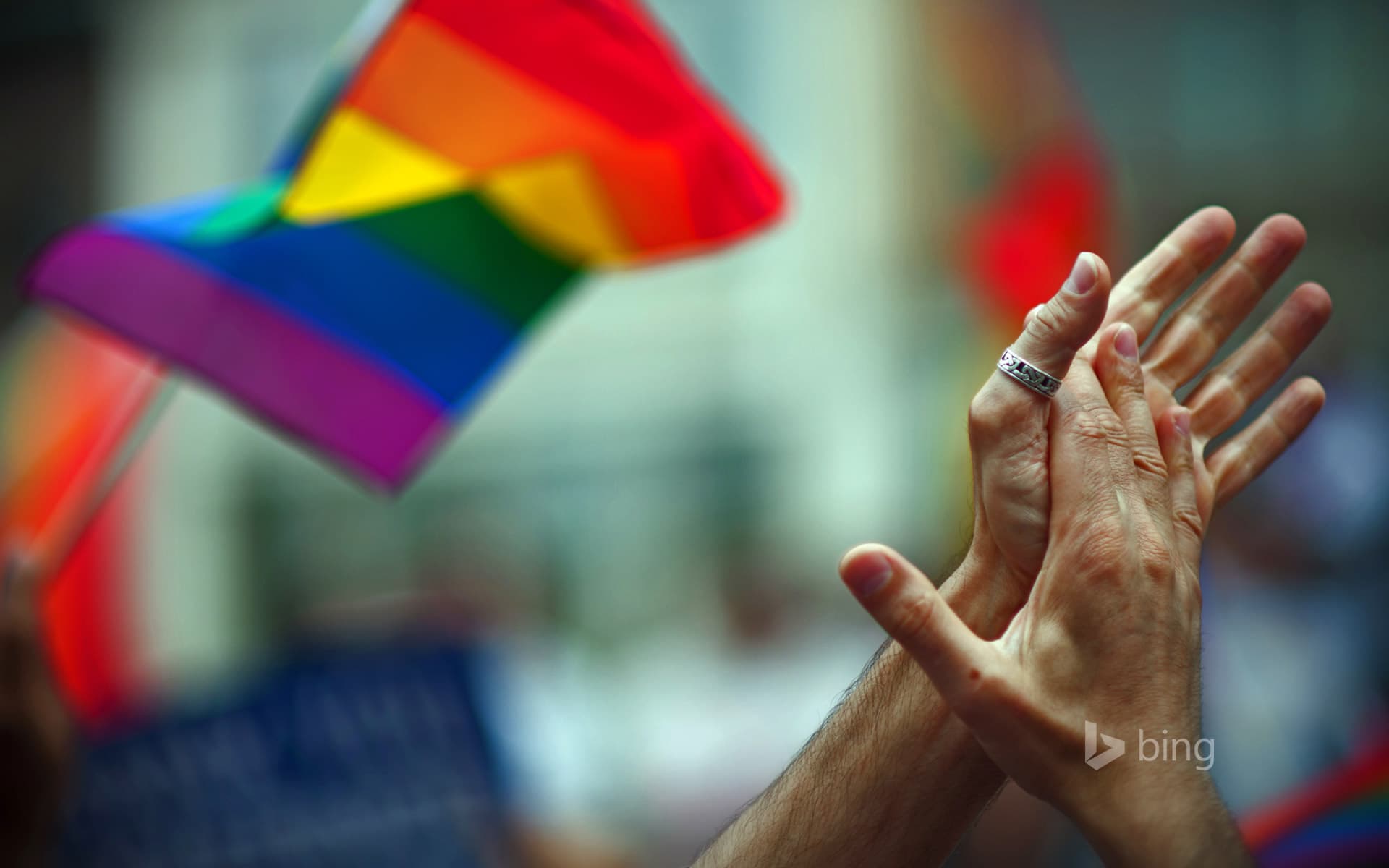 Bing Wallpaper: Rainbow flag and clapping hands