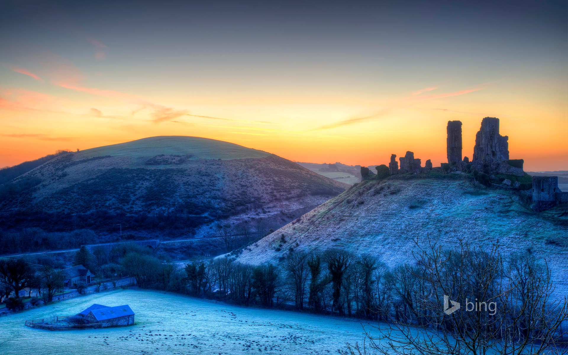 Bing Wallpaper: Colourful sunrise over Corfe Castle, Dorset, United Kingdom