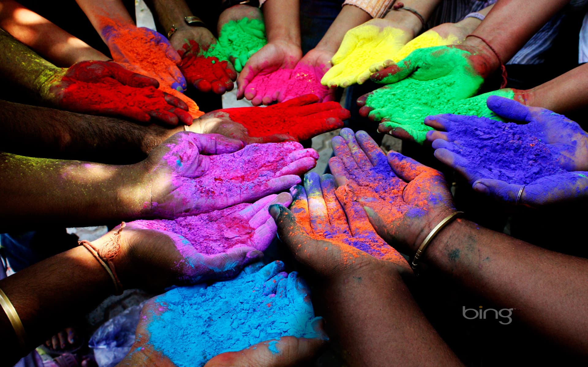 Bing Wallpaper: People holding colored powders to celebrate Holi (Festival of Colors) in Ahmedabad, India