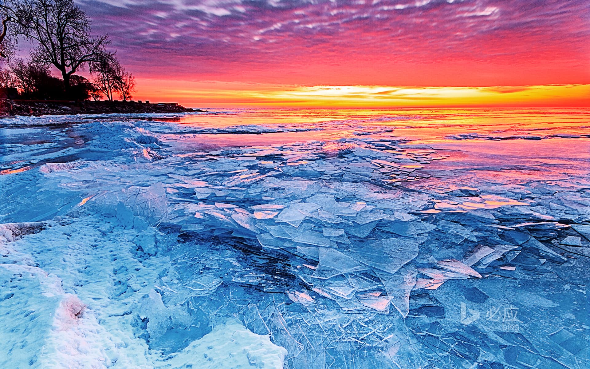 Bing Wallpaper: Ice and fire, rising sun over frozen Lake Erie