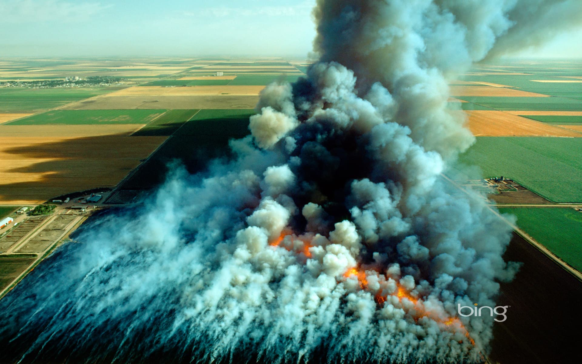 Bing Wallpaper: Aerial view, wheat field stubble burn, Kansas