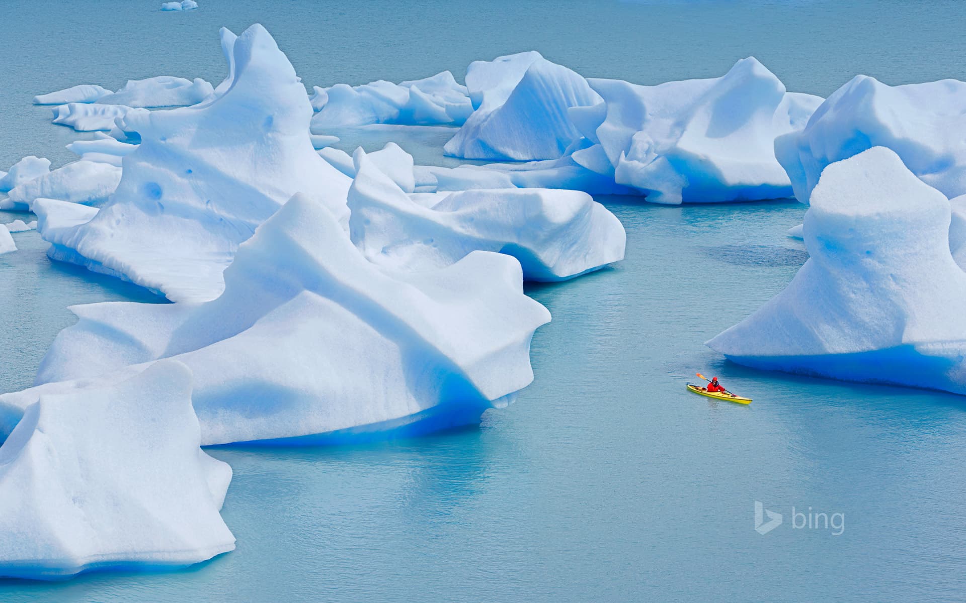 Bing Wallpaper: A kayaker crosses Grey Lake in Torres del Paine National Park, Chile