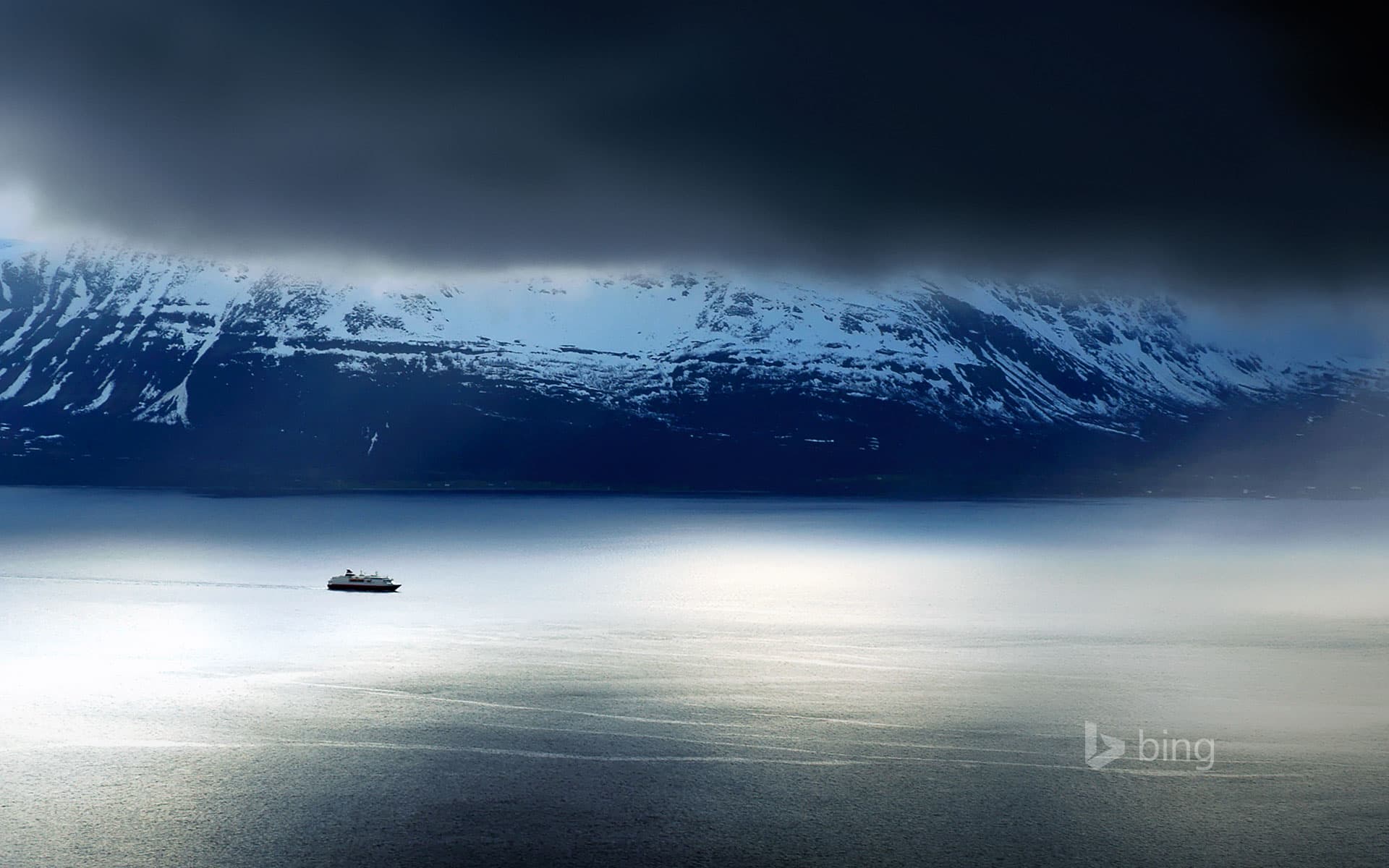 Bing Wallpaper: A ferry passes the Lyngen Alps in Norway