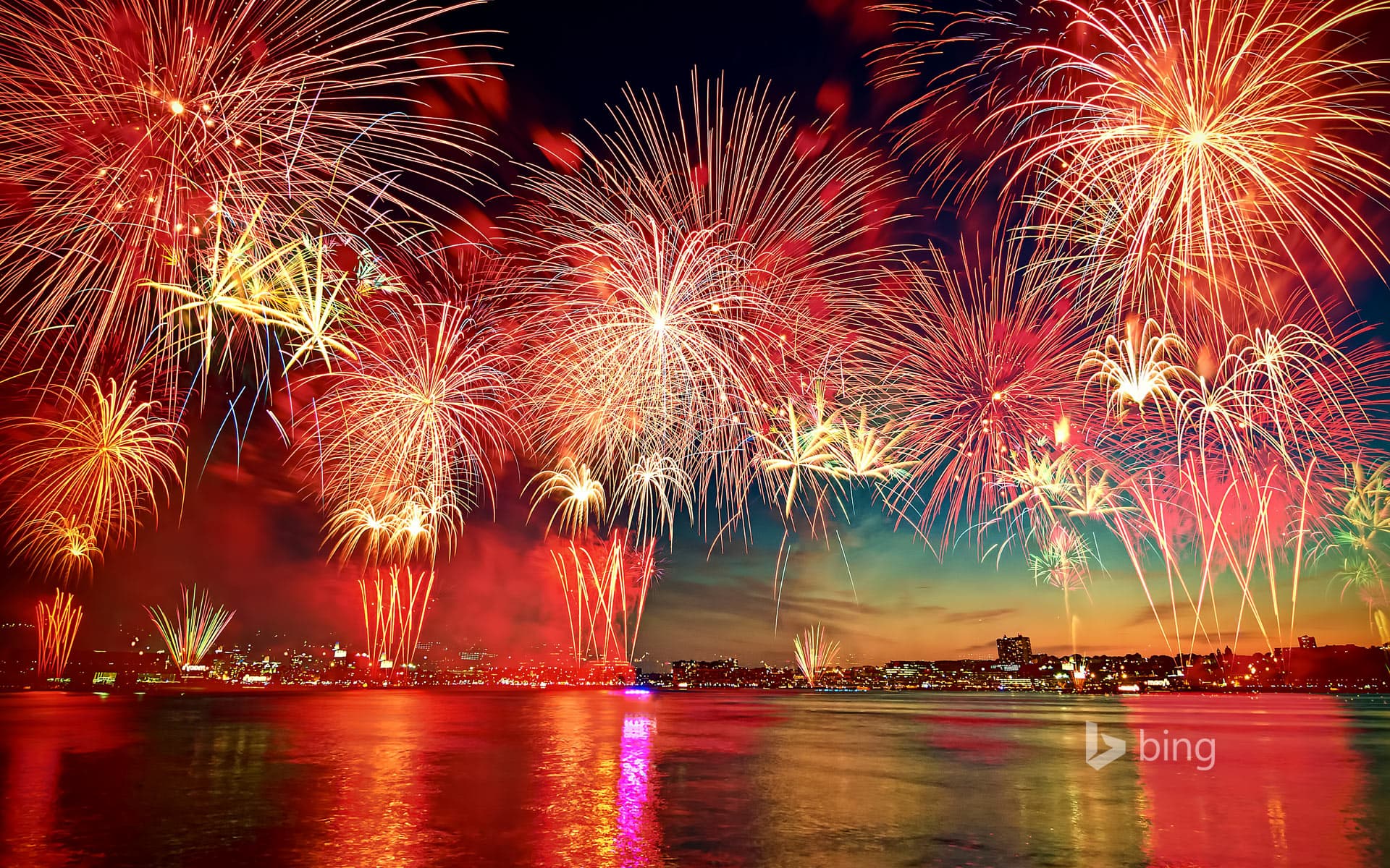 Bing Wallpaper: Fireworks display in New York City as seen over the Hudson River from Hoboken, New Jersey