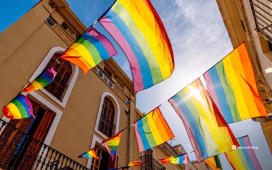 Street with LGBTQI+ pride flags, Sitges, Catalonia, Spain