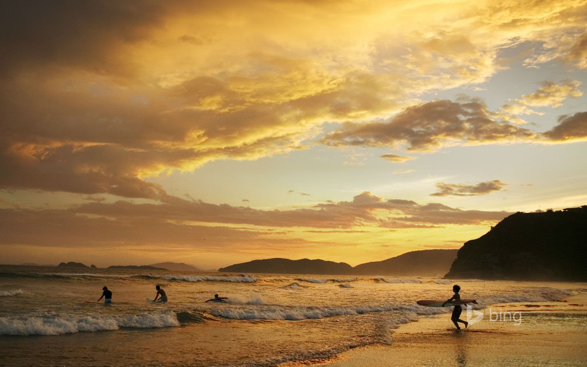 Bing Wallpaper: People surfing at dusk, Geriba Beach, Buzios, Brazil